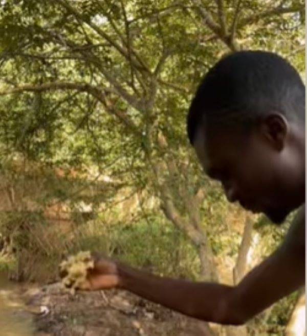 A man offering kenkey as sacrifice to the river god