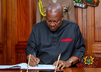 President John Dramani Mahama writing in a visitors book on his arrival in Kenya