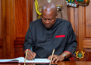 President John Dramani Mahama writing in a visitors book on his arrival in Kenya