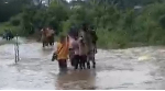 Students are seen walking through flood