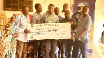 Emmanuel Senanu presenting the cheque to members of the Lepers Aid Committee