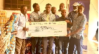 Emmanuel Senanu presenting the cheque to members of the Lepers Aid Committee