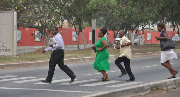 File photo of pedestrians crossing a road