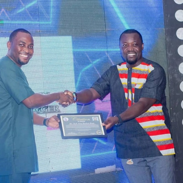 Kofi Atta Kakra Kusi (right) receiving his honorary award