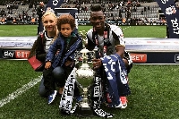 late Christian Atsu poses with his wife and kid after winning a trophy for Newcastle