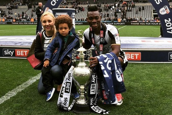 late Christian Atsu poses with his wife and kid after winning a trophy for Newcastle