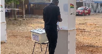 An individual casting his ballot