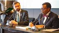 AfDB President Akinwumi Adesina (right) signs a document