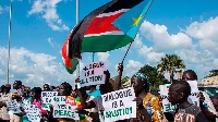 People hold up banners calling for dialogue in Juba