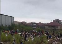 A file photo of residents picking washed away goods in the rain