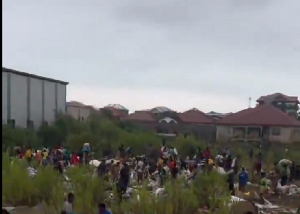 A file photo of residents picking washed away goods in the rain