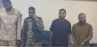 Reagan Amponsah Asare (L) visibly moved to tears while police officers took their mugshots