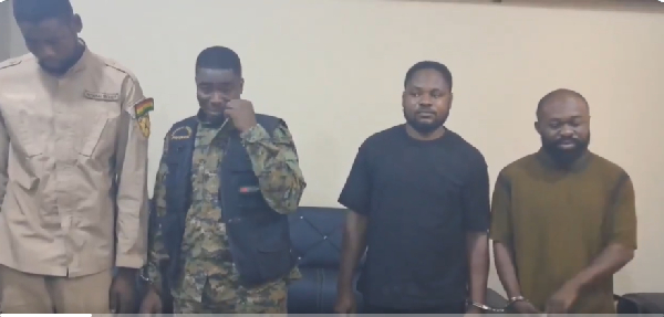 Reagan Amponsah Asare (L) visibly moved to tears while police officers took their mugshots
