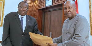 Chairman of the investigative committee, Justice Pwamang presenting the report to President Mahama
