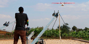 A technician of California-based robotics company Zipline launches a drone,in Muhanga, Rwanda
