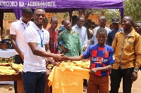 The NGO giving out school uniforms to some pupils of Abomayaw basic school