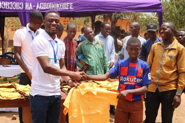 The NGO giving out school uniforms to some pupils of Abomayaw basic school