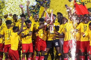 Players of Kotoko celebrating with the FA Cup trophy