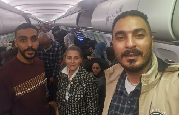 Hanan Jarrar, Palestinian ambassador to South Africa, smiles for a picture on the plane to S.A