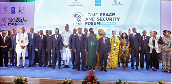 Heads of State, seasoned mediators, and security experts pose fo a photo at a forum in Togo