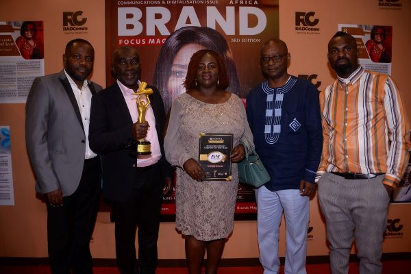 Ernest Poku, Facility Manager Afriwave (2nd left), displaying the award with other staff members
