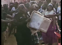 The police officer running with the ballot box