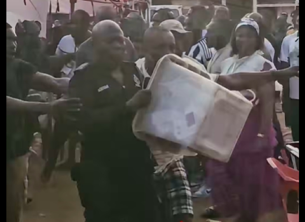 The police officer running with the ballot box