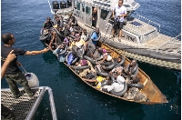 Migrants seen in a metal boat during an operation by the Tunisian National Guard against migrants