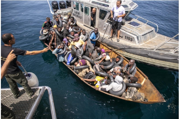 Migrants seen in a metal boat during an operation by the Tunisian National Guard against migrants