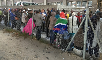 A Home Affairs representative collects asylum seekers’ documents
