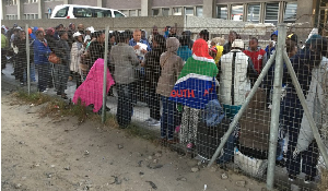 A Home Affairs representative collects asylum seekers’ documents A Home Affairs representative collects asylum seekers’ documents