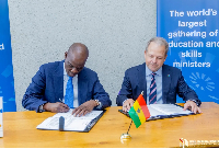 Minister for Education, Haruna Iddrisu (Left) is seen sighning a document