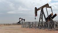 Oil pumps work in the desert oil fields of Sakhir, Bahrain