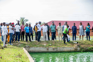 The minister (middle in white) with some of the people on the tour with her