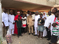 Naa Koryoo together with some party officials in a photograph with the bereaved family