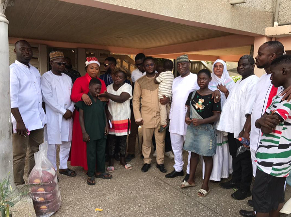 Naa Koryoo together with some party officials in a photograph with the bereaved family