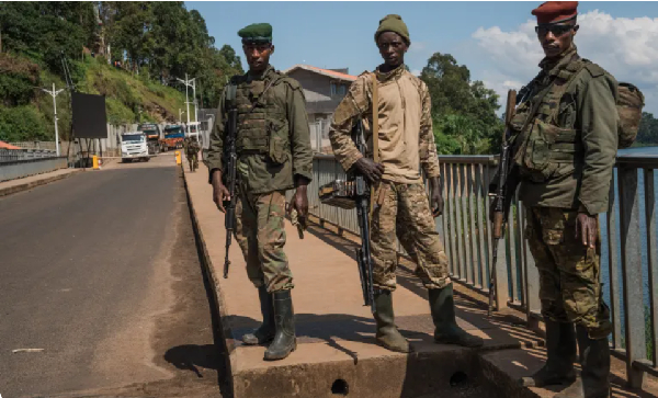 M23 rebel troops arrive at the Rusizi border post in Cyangugu, Rwanda