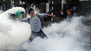 Protester lobs tear gas