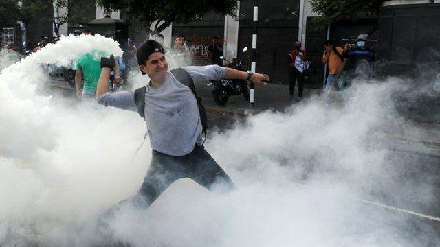 Protester lobs tear gas