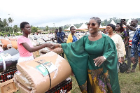 Dorcas Affo-Toffey in a hand shake with one of the beneficiaries