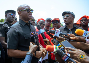 Deputy Chief of Staff Stan Dogbe behind the microphone with the petition in his hands