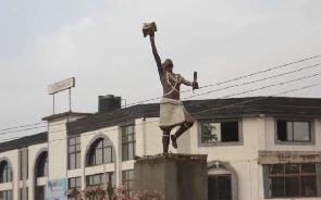 A statue of Komfo Anokye at a roundabout in the Ashanti Region