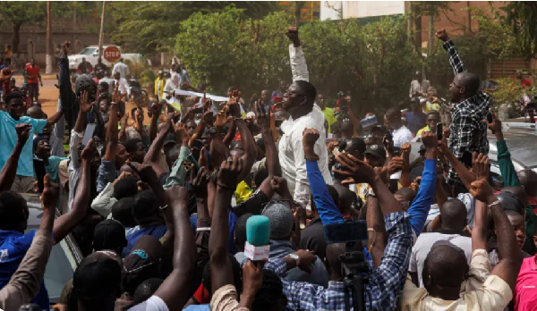 Pro-democracy youth leader Cheick Oumar , (C), chants slogans surrounded by supporters protesting