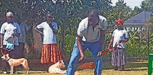 Robert Onen, an ex-Lord’s Resistance Army (LRA) combatant, plays with his therapy dog