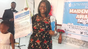 An award recipient displaying her award and citation