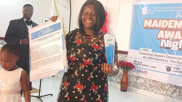 An award recipient displaying her award and citation