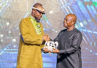 Kofi Okyere-Darko (KOD), the Creative President of NINETEEN57 [L] receiving the trophy