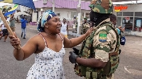 A civilian with a military man in Gabon. Credit: REUTERS