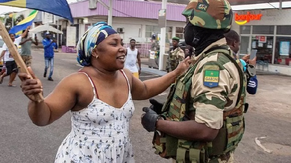 A civilian with a military man in Gabon. Credit: REUTERS