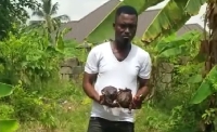 Photo of Pastor Yaw Paul holding the alleged 'juju'